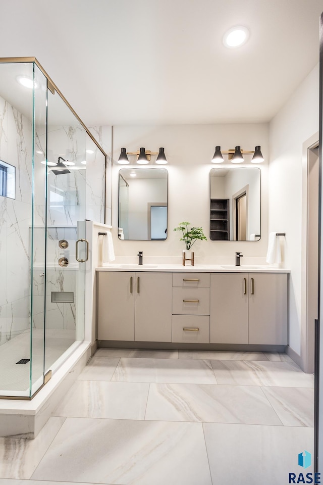 bathroom with vanity and a shower with door