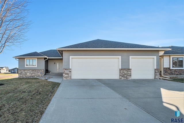 prairie-style home with a front yard and a garage