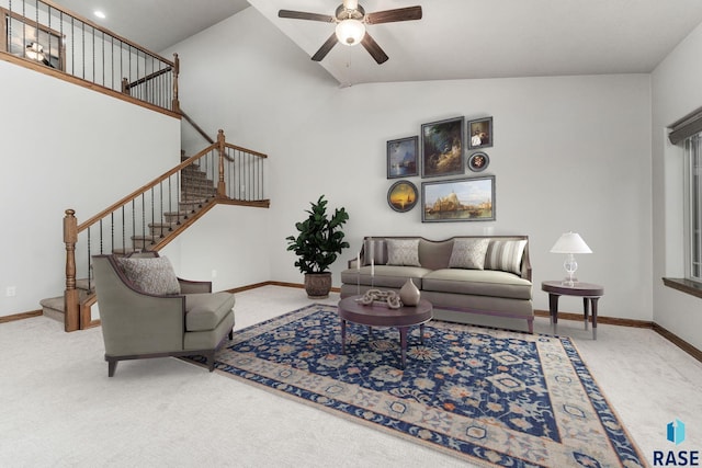 living room with ceiling fan, carpet floors, and high vaulted ceiling