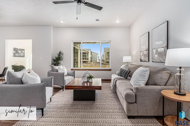 living room with ceiling fan and wood-type flooring