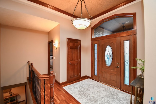 entrance foyer featuring hardwood / wood-style flooring and ornamental molding