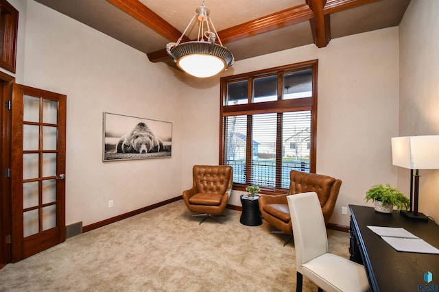 carpeted office space with beam ceiling and french doors