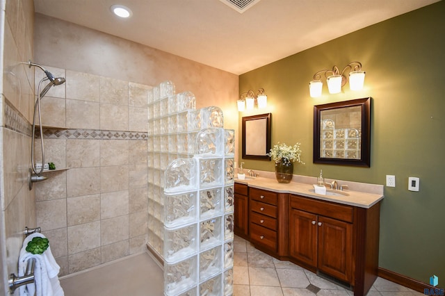 bathroom featuring tile patterned floors, vanity, and tiled shower