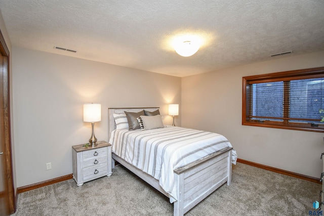 carpeted bedroom featuring a textured ceiling