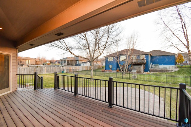 wooden deck featuring a lawn