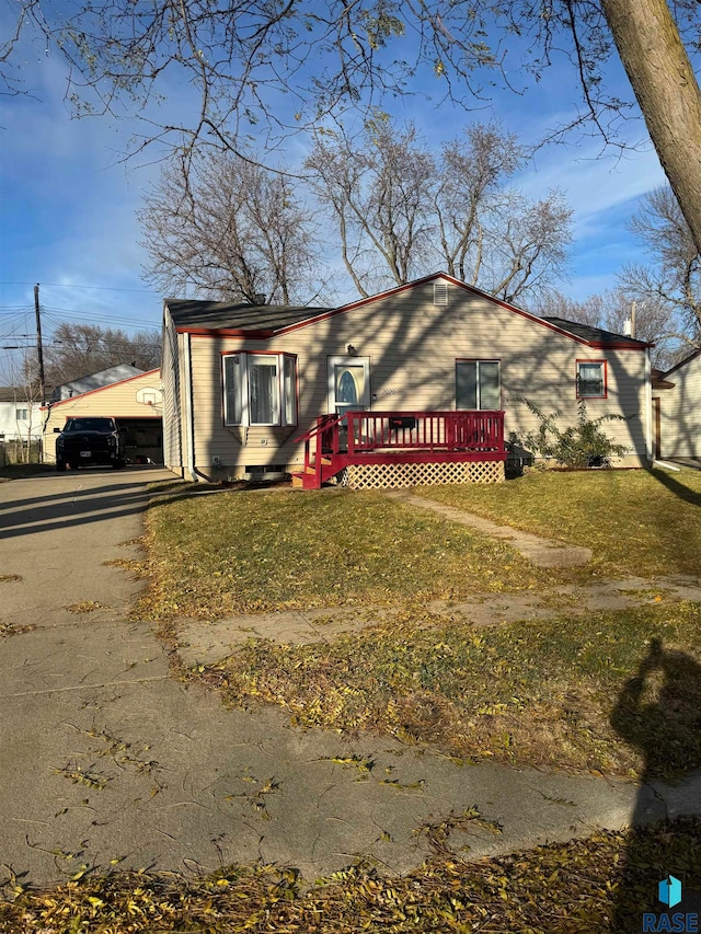 view of front of house featuring a front yard and a deck