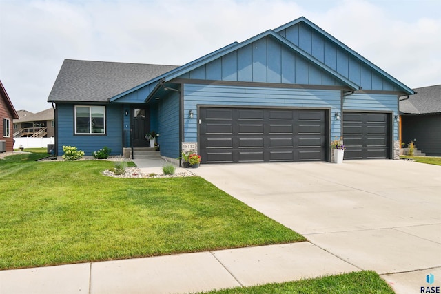 view of front of home featuring a garage and a front lawn