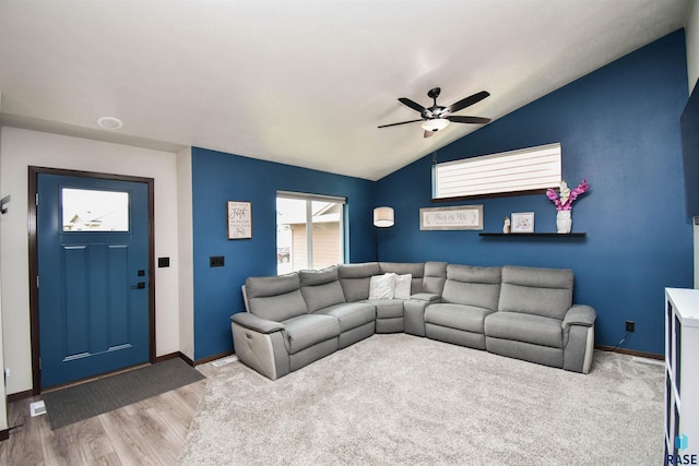 living room featuring hardwood / wood-style floors, ceiling fan, and lofted ceiling