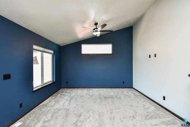 carpeted spare room with ceiling fan and lofted ceiling