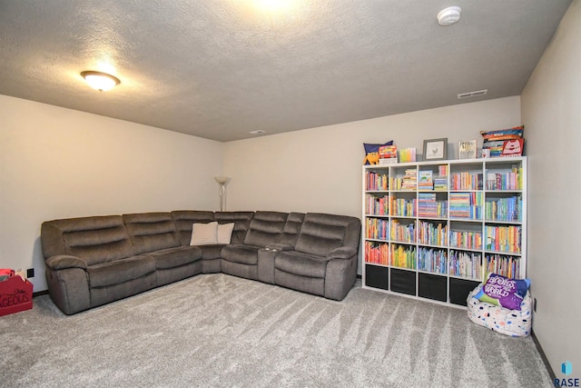 carpeted living room featuring a textured ceiling