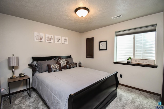 carpeted bedroom featuring a textured ceiling