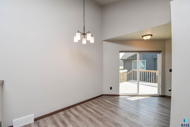 interior space with a notable chandelier and hardwood / wood-style flooring