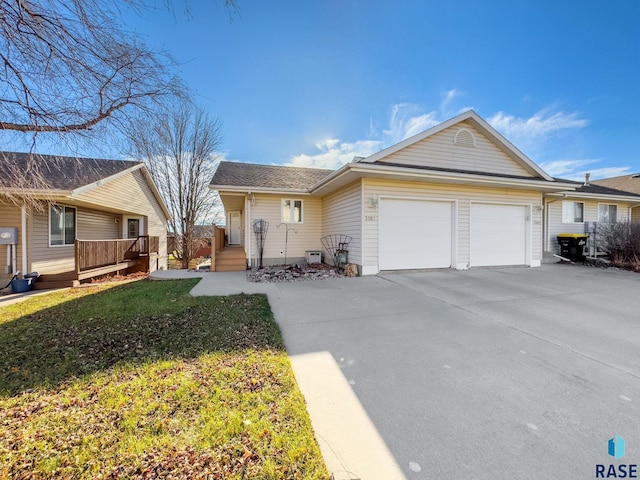 ranch-style home with a front yard and a garage