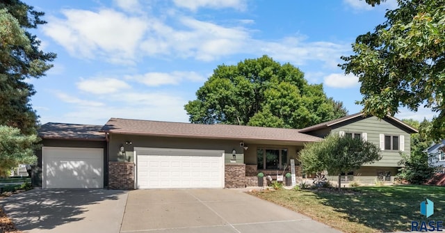 view of front of home with a front yard and a garage