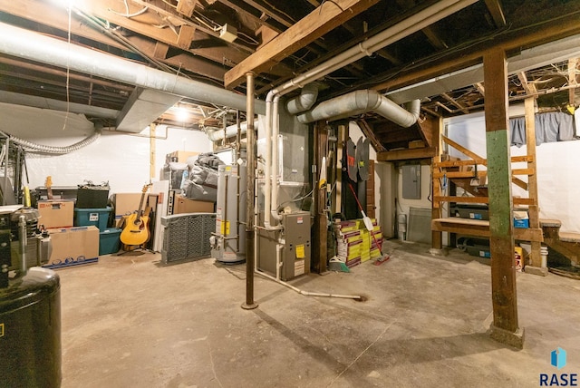 basement with heating unit, electric panel, and water heater