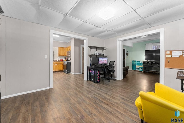 office area featuring a paneled ceiling and dark wood-type flooring