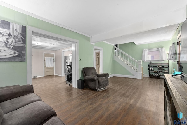 living room featuring dark hardwood / wood-style flooring and crown molding