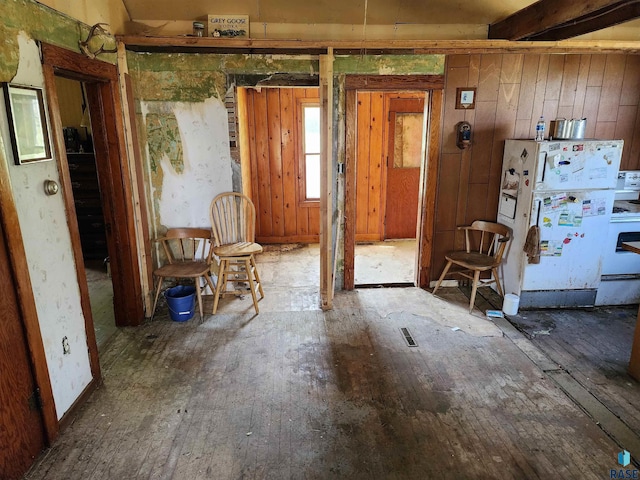 misc room featuring wooden walls and hardwood / wood-style flooring