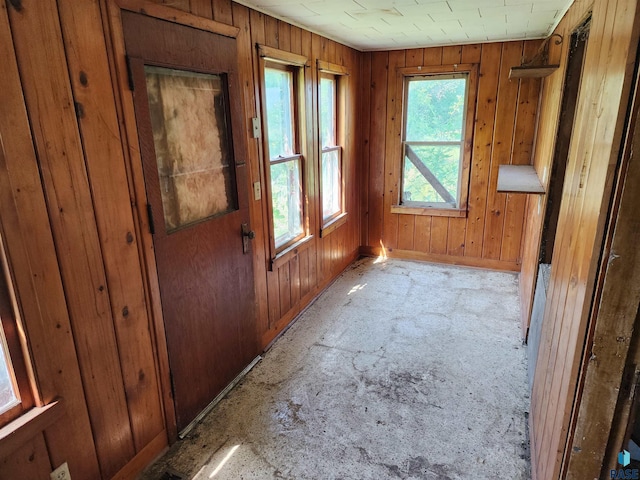 doorway to outside featuring wood walls