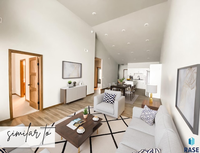 living room featuring light hardwood / wood-style floors and high vaulted ceiling