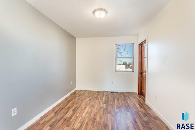 empty room featuring dark wood-type flooring