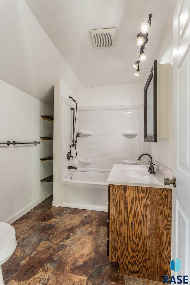 full bathroom featuring vanity, toilet, and tiled shower / bath