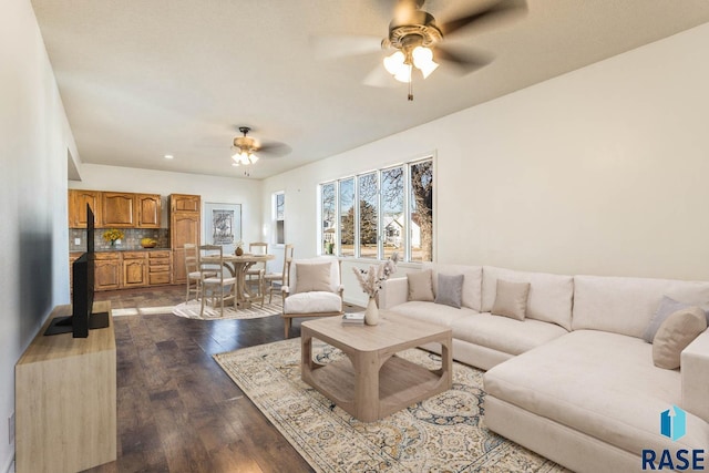 living room with dark hardwood / wood-style floors and ceiling fan