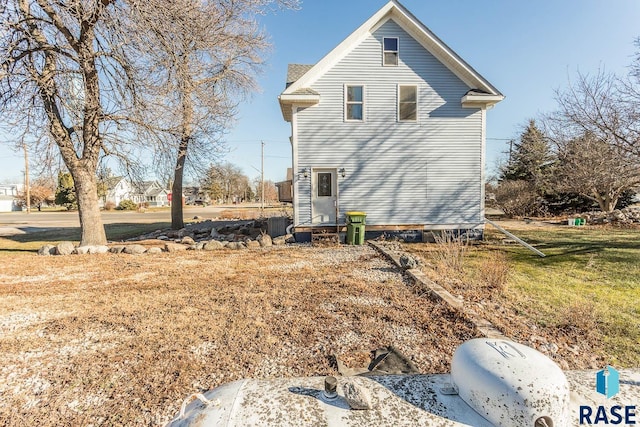 view of side of home featuring a yard