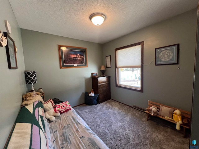 bedroom featuring carpet flooring and a textured ceiling