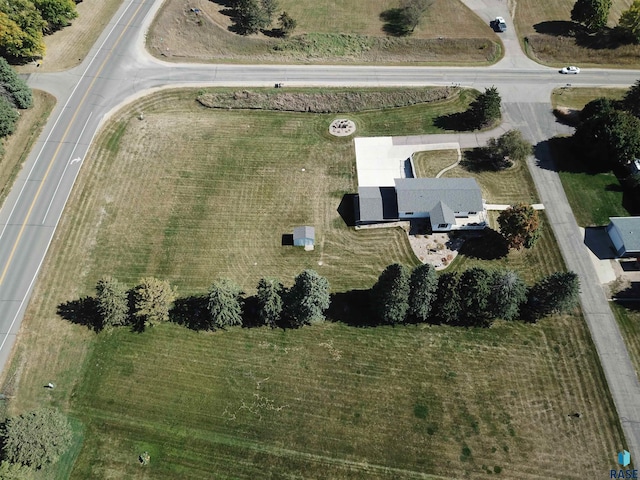 birds eye view of property with a rural view