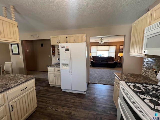 kitchen featuring a textured ceiling, ceiling fan, dark hardwood / wood-style floors, and white appliances