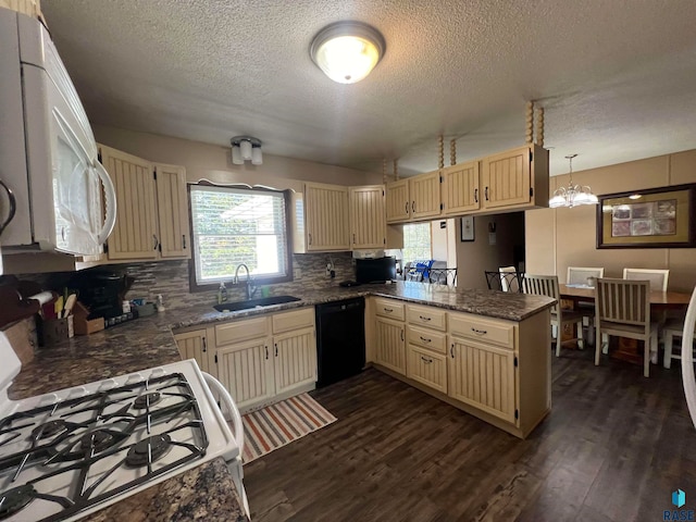 kitchen with kitchen peninsula, dark hardwood / wood-style flooring, white appliances, sink, and pendant lighting