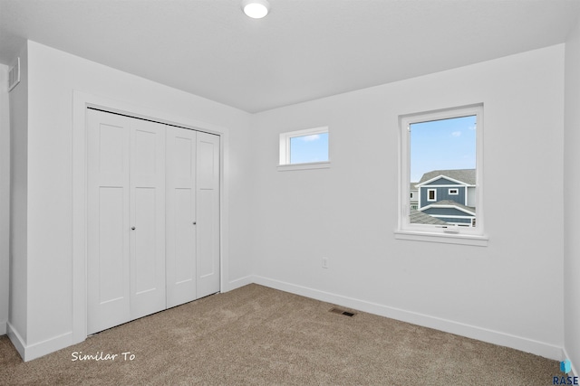1271 N Marion Rd Unit 2, Sioux Falls, SD 57107 - unfurnished bedroom with baseboards, carpet, and a closet