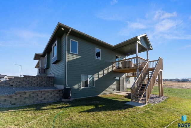 back of house with a lawn and a deck