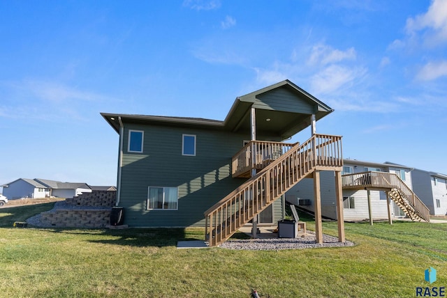 rear view of property with a wooden deck and a lawn