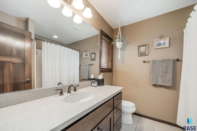 bathroom with tile patterned flooring, vanity, and toilet