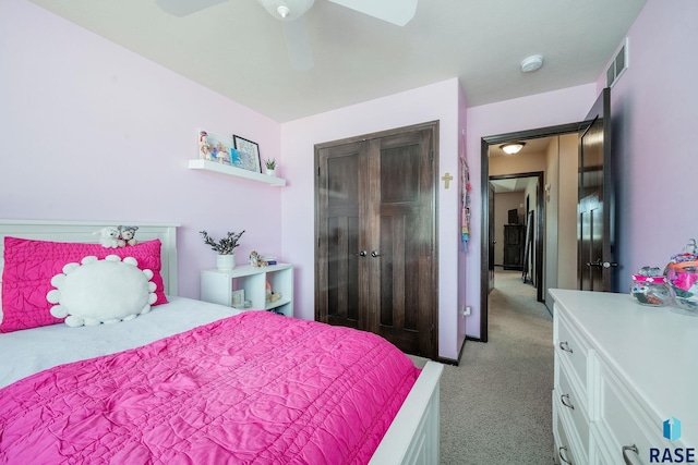 bedroom featuring ceiling fan, light colored carpet, and a closet