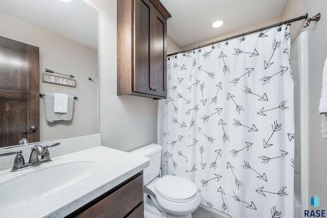 bathroom with vanity, toilet, and curtained shower