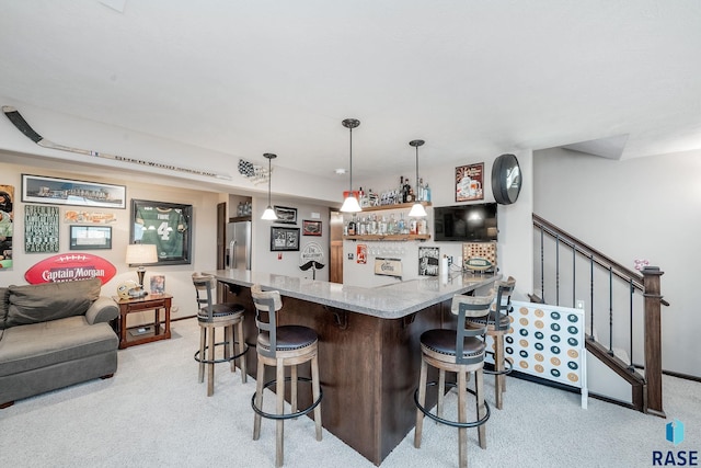 kitchen featuring stainless steel refrigerator with ice dispenser, kitchen peninsula, light colored carpet, decorative light fixtures, and a kitchen bar