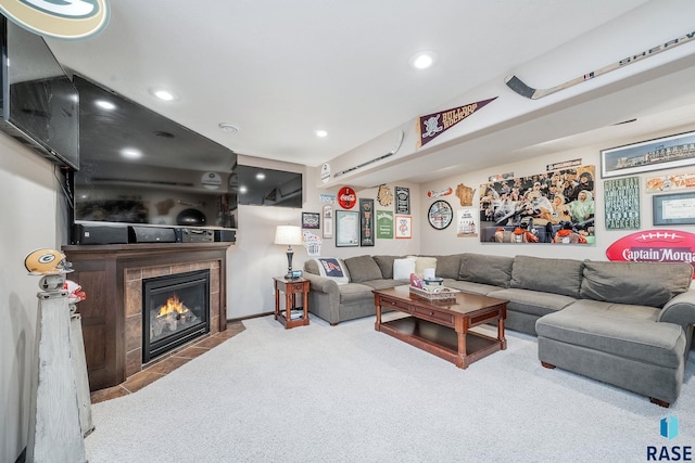 living room with a tile fireplace and light carpet