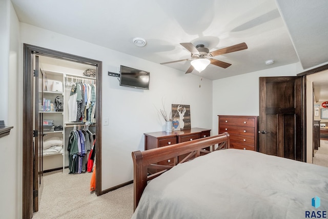 carpeted bedroom featuring ceiling fan and a closet