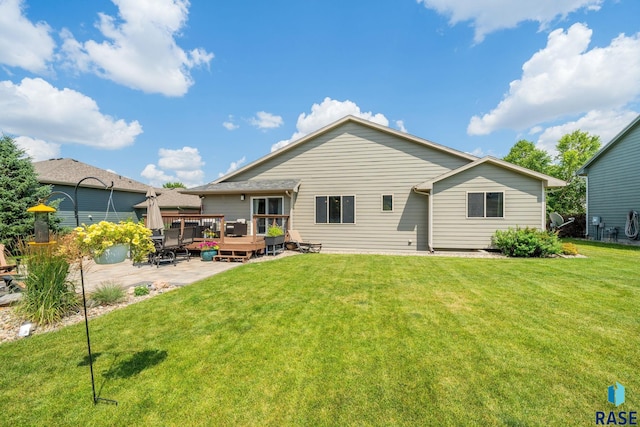 back of property with a lawn and a wooden deck