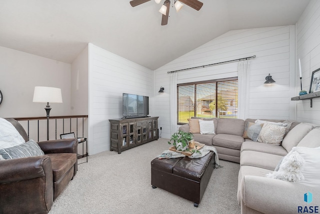 living room with light colored carpet, vaulted ceiling, ceiling fan, and wooden walls