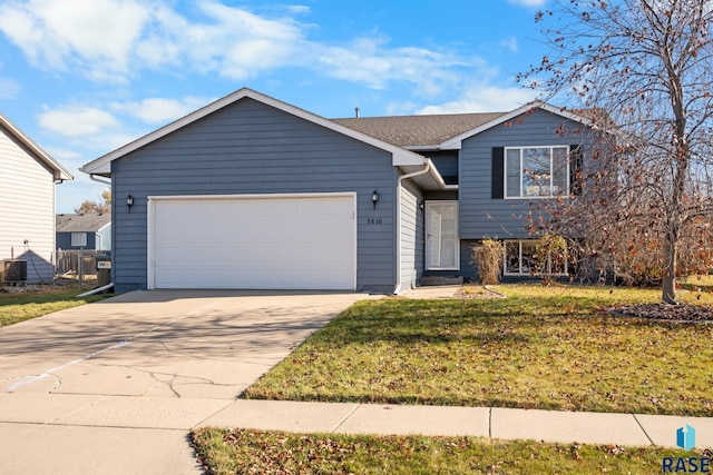 view of front of property with a garage and a front lawn