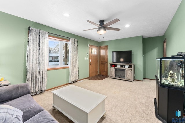 living room featuring light carpet and ceiling fan