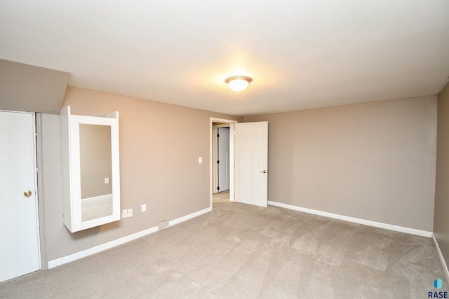 empty room featuring light carpet