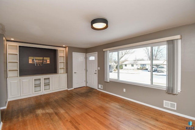 unfurnished living room with wood-type flooring