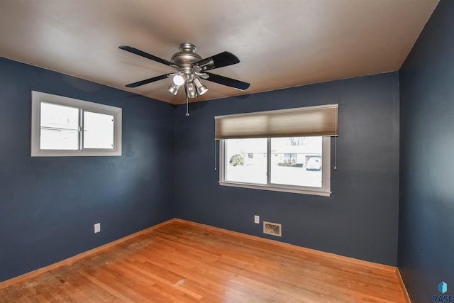 empty room with light hardwood / wood-style floors and ceiling fan