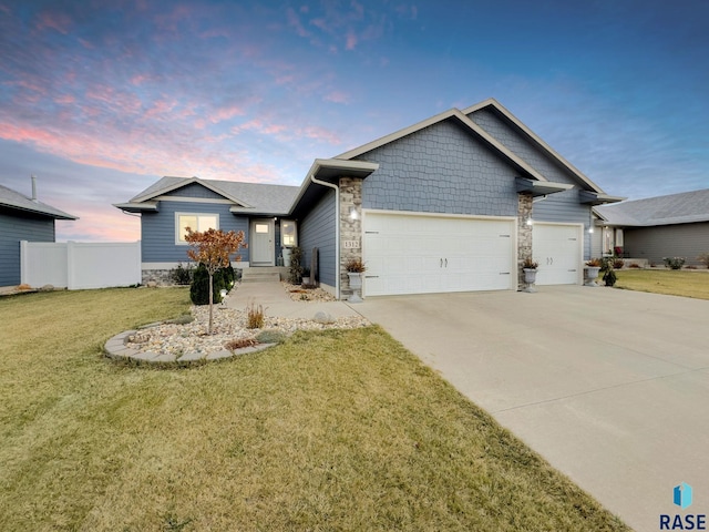 view of front of home featuring a garage and a yard