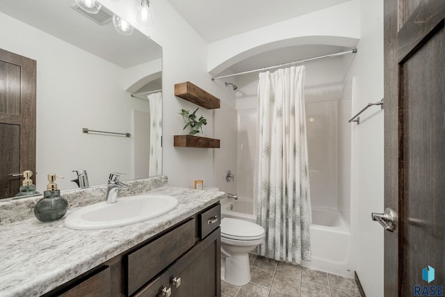 full bathroom featuring toilet, shower / bath combo, vanity, and tile patterned floors